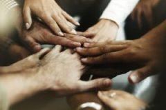 Closeup of diverse people joining their hands
